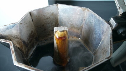 Coffee coming to the surface inside expresso moka, preparing caffeine drink in the morning brew