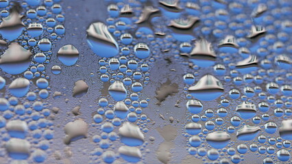 Droplets on window caused by condensation, macro perspective of bubbles on glass surface