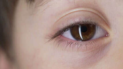 Fototapeta na wymiar Extreme macro close-up of child's eye looking at camera. retina iris eyesight of kid