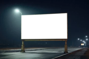 Zelfklevend Fotobehang Snowflakes fall gently on a quiet highway, illuminated by a lone streetlight with an empty billboard standing stark against the night © gankevstock
