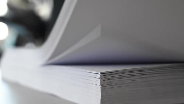 Turning or flip scroll paper in the print shop during bookbinding and cutting, collating stack paper.