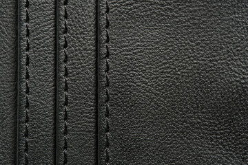 Background is made black leather stitched with black threads.