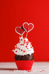 Cupcake love: Heart-themed treats on a vibrant red backdrop