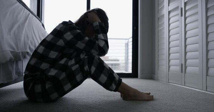 Bedroom, scared or sad woman with depression in home with broken heart, mistake or bad news. Morning, ptsd or frustrated female person on floor with stress anxiety, grief or negative memory at home