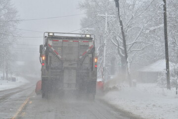Snow Plow on a Snowy Road