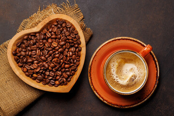 Coffee love: A cup and heart-shaped bowl with roasted beans