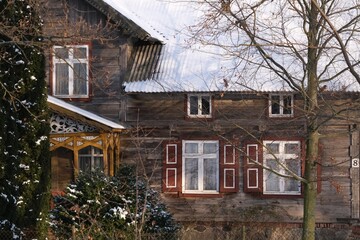 Traditional wooden building among branches of tree by Motlawa river on Zulawy Gdansk, Grabowo, Poland