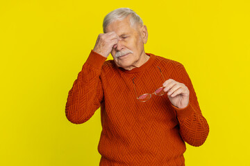 Exhausted tired senior old man takes off glasses feels eyes pain, being overwork burnout from long...