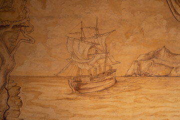 Bas-relief of an old wooden ship with white sails sailing on the Black Sea against the backdrop of...