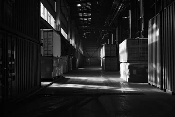  A black and white photo of a warehouse. Suitable for industrial concepts or architectural designs © Vladimir Polikarpov