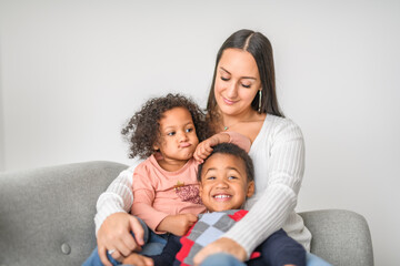 Fototapeta premium family with boy and girl child posing on photo shooting, sitting on couch