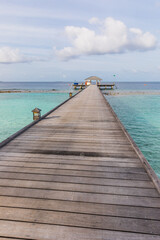 Fototapeta premium Wooden pier on a tropical beach in the Maldives