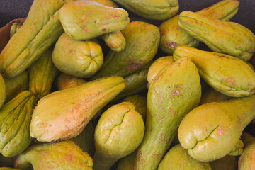 A pile of green chayote squash (Sechium edule), close up view. 