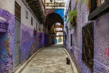 Fototapeta na wymiar Historical tiny street with indigo blue houses in the old Medina, Jewish quarter in Fez.