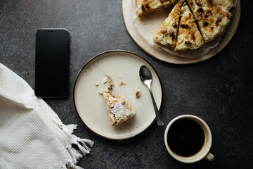 Having meals with smartphone. Using cell phone while eating. Homemade pie on concrete table. Top...