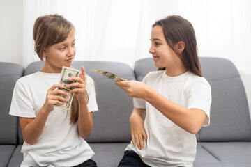 Photo of lucky caucasian girls wearing casual clothing holding fans of dollars in hands 
