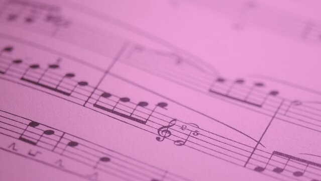 Detail of score on staff with changing colors of light
