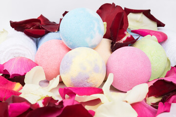 colorful dissolving balls for taking a spa bath in rose petals, close-up