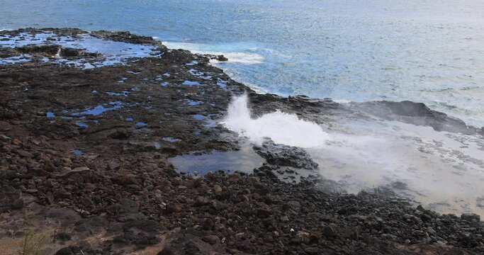 Spouting Horn blow hole coast Kauai Hawaii. Crashing ocean surf waves. Tourist Hawaiian seascape recreation. Garden Isle. Volcanic mountain lava rocky coast geology. Pacific ocean.