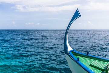 bow of a traditional Maldivian dhoni boat in the Indian Ocean lagoon in the Maldives