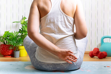 Woman makes her yoga and meditation practice at home. Healthy lifestyle and home fitness concept.
