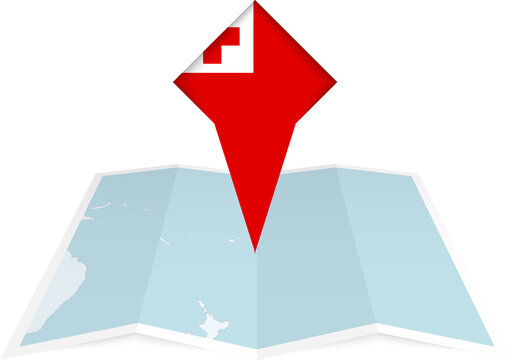 Tonga pin flag and map on a folded map