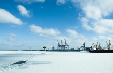 Winter shipping. Big cargo ships in frozen ice sea fairway