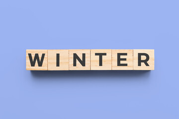 winter wooden cubes on blue background