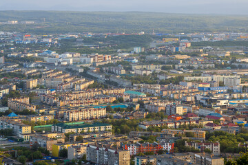 Morning cityscape. Top view of the buildings and streets of the city. Residential urban areas at sunrise. Beautiful aerial city landscape. Petropavlovsk-Kamchatsky, Kamchatka Krai, Far East of Russia.
