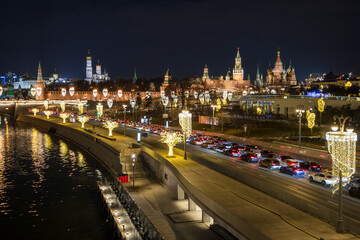 Moscow, Russia. Top view of Moskvoretskaya embankment. There is a traffic jam on the roadway. Many cars in a traffic jam. The Moscow Kremlin is in the distance. Beautiful street lighting.