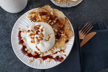 burrata is served with roasted caramelized pear and pine nuts.