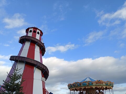Amusement park Helter Skelter against bloue sky and clouds