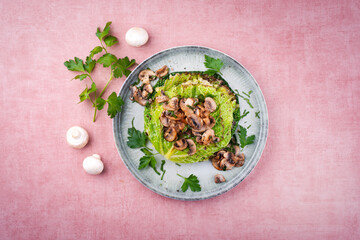 Traditional savoy cabbage lasagne with mashed potatoes and mushrooms served as top view on a design plate with text space