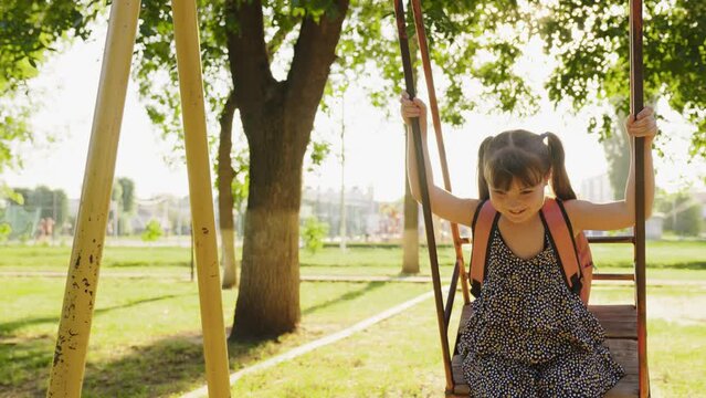 happy girl rides swing park, child ride swing playground, happy family, children dream flying, children's playground, family fun playground, children play outdoors, happy eyes kid schoolgirl daughter,