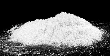 Pile of white snow isolated on a black background. White fluffy snow.