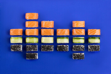 sushi and rolls in the form of an equalizer on a blue background