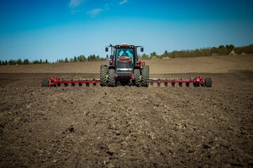 Obraz premium red tractor working in the field