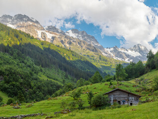 The chalet under Hineres Lauterbrunnental valley with the peaks Mittaghorn and Grosshorn and...