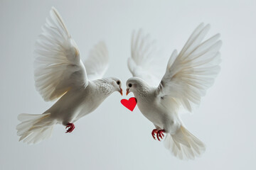 Obraz premium A couple of white wedding dove, symbolizing peace and love, soars with outstretched wings in the bright sky.