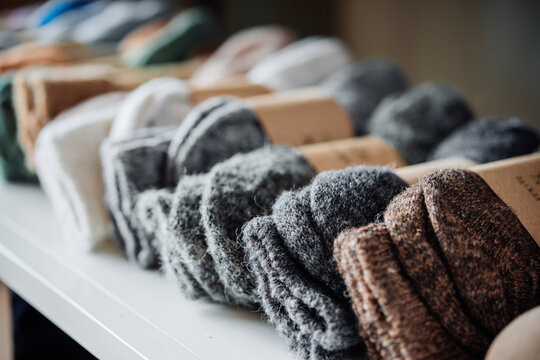 Colourful winter socks on sale in a retail shop. Fashion and shopping concept.