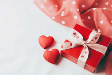 Red gift box with white ribbon and two hearts on white background. Copy space for text. Present for Valentine's Day, Birthday, Women's Day. Flat lay. For banner, poster, card, postcard