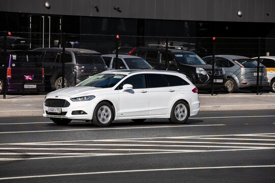 Ford Mondeo Turnier estate car moving on the street. Estate vehicle driving along the street in city