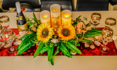 Naklejka na ściany i meble Centerpieces: Centerpieces are decorative elements placed at the center of the table to enhance the overall aesthetics. A restaurant's table setup is a carefully arranged configuration of furniture