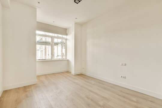 Empty room with white walls and window