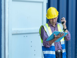 male man person people human wear safety hardhat helmet yellow colour holding hand body part talkie walkie radio look see report checklist order import export cargo import export logistic construction