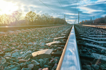 railway, rails and sleepers close-up at sunset under a stormy sky