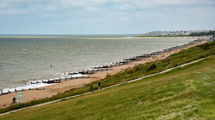 Unrecognized people walking on a public coastal footpath. People active. Healthy lifestyle.