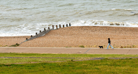 Unrecognized people walking on a public coastal footpath. People active. Healthy lifestyle.