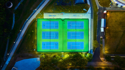 Aerial Top Down View of Illuminated Tennis Courts at University Campus