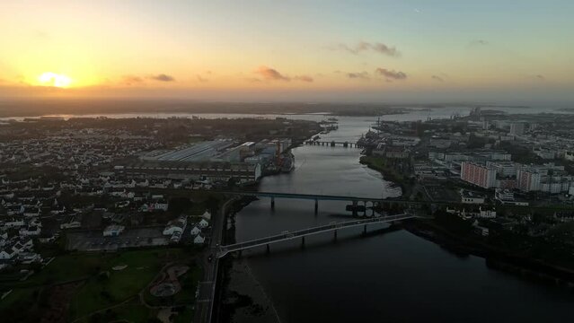Sunrise over Lorient's industrial harbor.